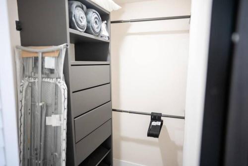 a closet with white drawers and a door at Live in style! apartment in North Miami Beach