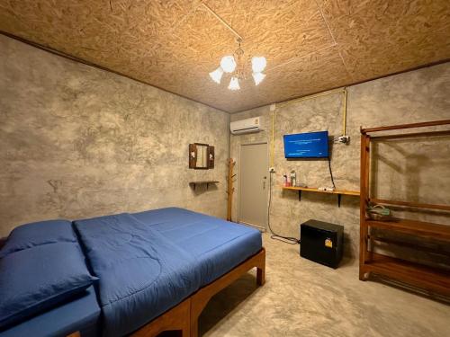 的住宿－Fatima homestay ฟาติมาโฮมสเตย์，一间卧室配有蓝色的床和电视
