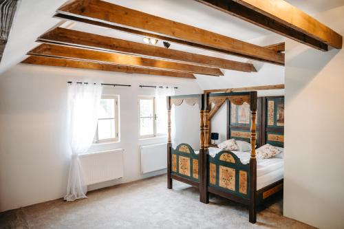 a bedroom with two bunk beds and a ceiling with beams at Château Rychvald in Ostrava