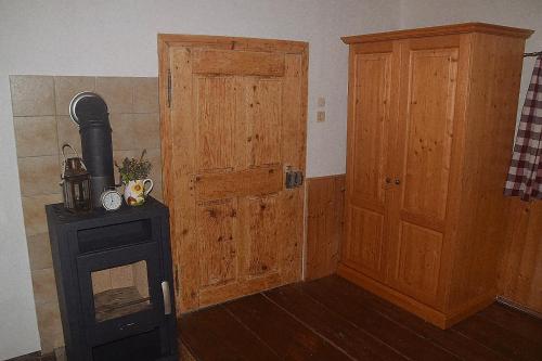 a room with a wooden door and a stove at Ferienhaus Masser in Mainsdorf
