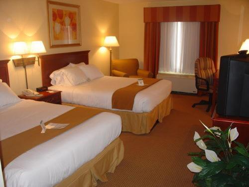 a hotel room with two beds and a flat screen tv at Holiday Inn Express & Suites - Muncie, an IHG Hotel in Muncie