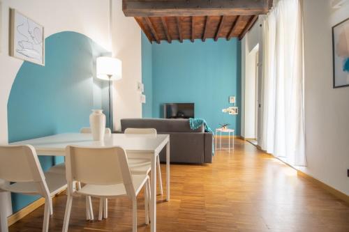 a living room with a table and chairs and a couch at Corte D'Appello Houses in Turin