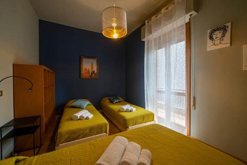 a bedroom with two beds and a window at Central Perk - NEW @ Brescia in Brescia