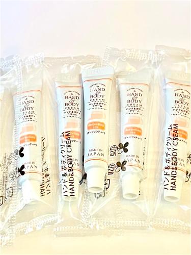 a group of four lotion bottles in a plastic container at Kansai Airport First Hotel in Izumi-Sano