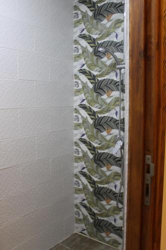 a bathroom with a patterned wall at TRAVEL SURF NATURE in Tamraght Ouzdar
