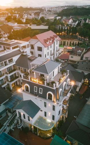 an overhead view of a large white house with lights at VMT Hotel Da Lat in Da Lat