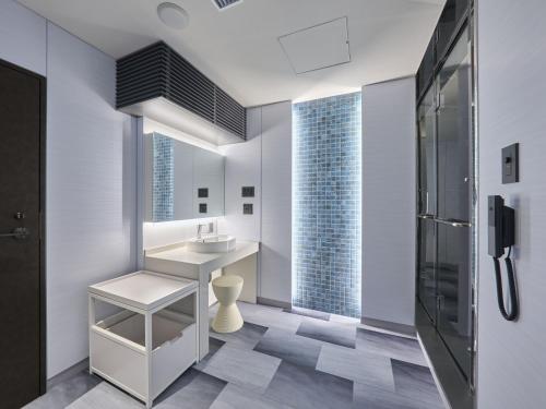 a bathroom with a sink and a shower at Villa Fontaine Grand Osaka Umeda in Osaka