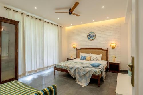 a bedroom with a bed and a ceiling fan at Apartment Santa Terra in Candolim