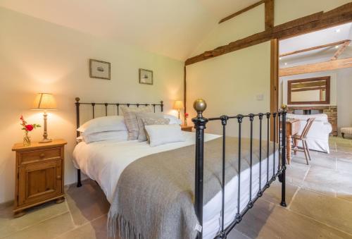 a bedroom with a large bed in a room at Hope Cottage - West Sussex in Henfield