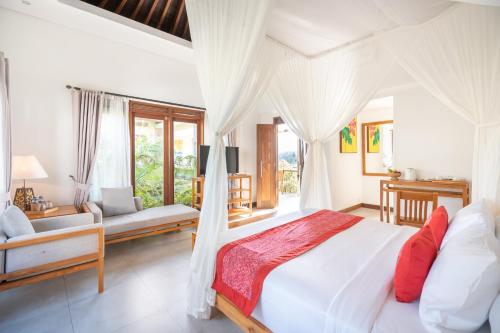 a bedroom with a white bed and a living room at Prabhu Ubud Villa in Ubud