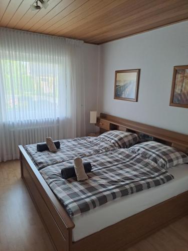 a bedroom with a large bed with two pillows on it at In der Heide in Löhne