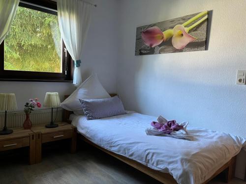 ein Schlafzimmer mit einem Bett mit Blumen darauf in der Unterkunft Sternenhimmel 2 in Thalfang