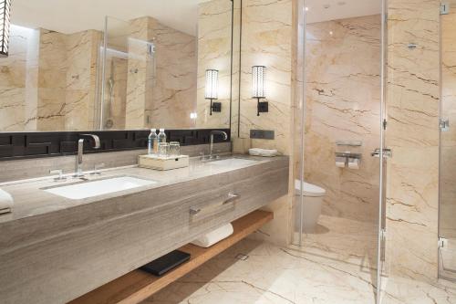 a bathroom with a sink and a shower at Conrad Tianjin in Tianjin