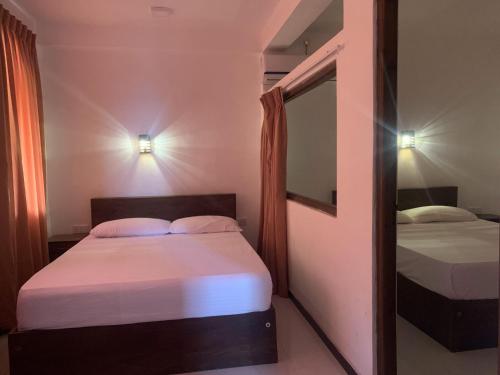 A bed or beds in a room at Nature Rock Dambulla