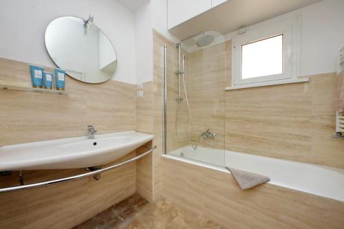 a bathroom with a sink and a shower and a mirror at On The Steps in Rome