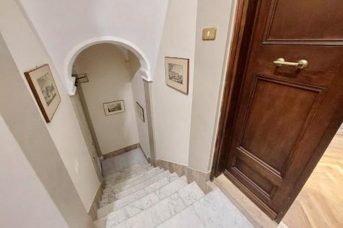 a hallway with a wooden door and a staircase at On The Steps in Rome