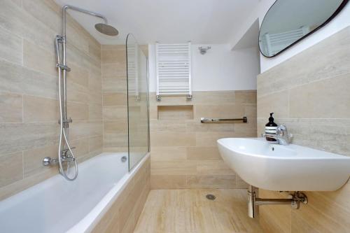 a bathroom with a white sink and a shower at On The Steps in Rome