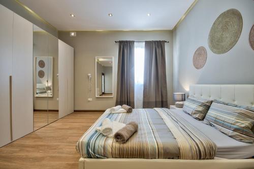 a bedroom with a large bed with towels on it at Villa Blu - Family Villa with Indoor heated Pool, Sauna and Games Room in Mellieħa