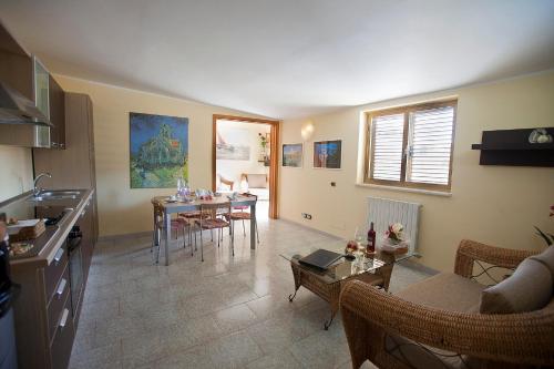 een keuken en een woonkamer met een tafel en stoelen bij Casa Vacanza Mediterraneokr - AAUT in Crotone