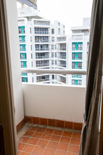 a balcony with a view of a tall building at Chatrium Sathon Bangkok in Bangkok