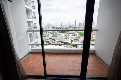 a view of a balcony from a window in a building at Chatrium Sathon Bangkok in Bangkok