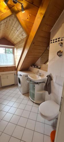 a bathroom with a sink and a washing machine at Apartment am Ammersee in Herrsching am Ammersee