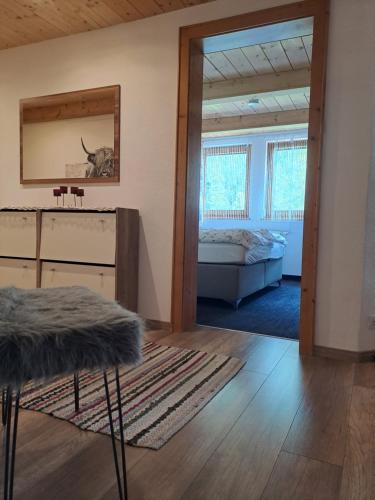 a living room with a bed and a mirror at Landgasthaus Appartement Birkegg in Leutasch