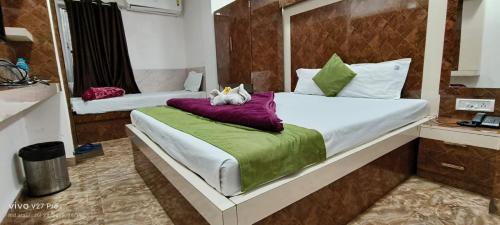 a bedroom with two cats laying on a bed at HOTEL BEST BUY in Kolkata