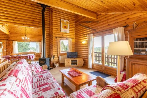 a living room with couches in a log cabin at Chalet les deux marmottes - Vue montagne in Bolquere Pyrenees 2000