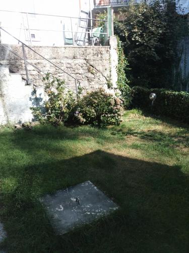 a yard with a grate in the grass at Gli Aristogatti in Campo Tizzoro