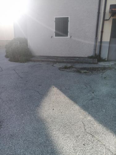 a shadow of a building and a window on a street at Gli Aristogatti in Campo Tizzoro