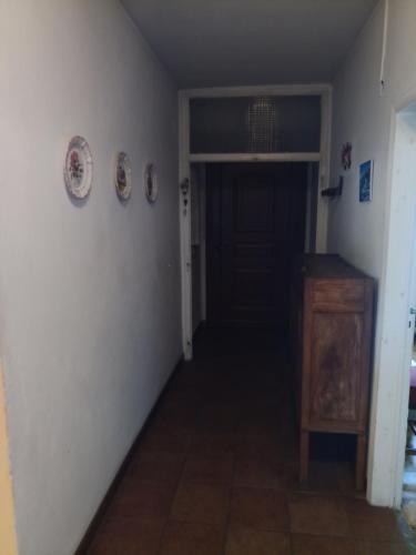 a hallway with a black door and a wooden cabinet at Gli Aristogatti in Campo Tizzoro