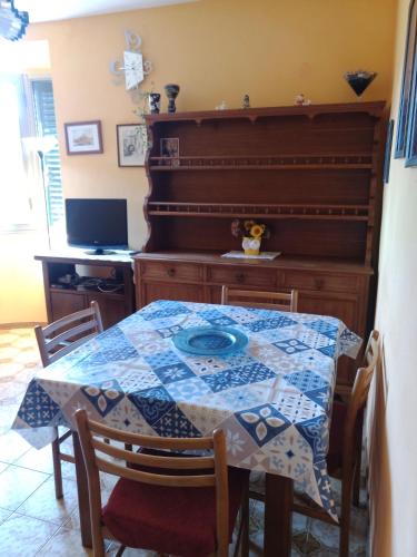 a dining room with a table and a piano at Gli Aristogatti in Campo Tizzoro