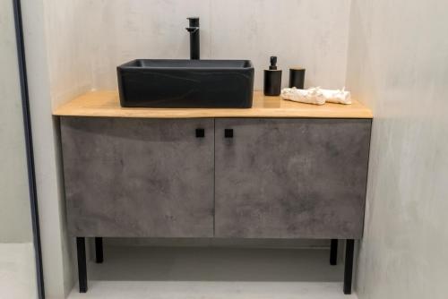 a counter with a sink on top of it at V.L.A Apartments by the sea in Vari