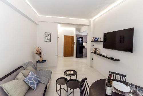 a living room with a couch and a table at V.L.A Apartments by the sea in Vari