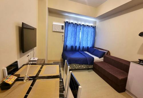 a small living room with a couch and a tv at Fully furnishd Avida condo 2(wi-fi netflx disney+) in Cagayan de Oro