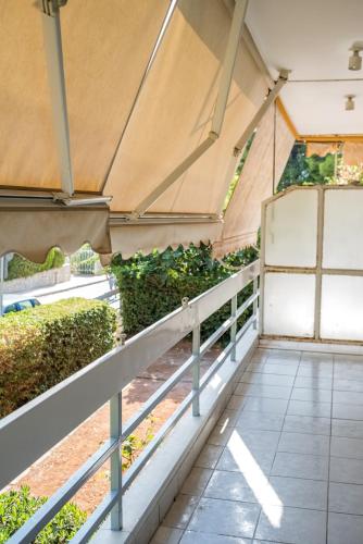 a greenhouse with a fence and plants at V.L.A Apartments by the sea in Vari