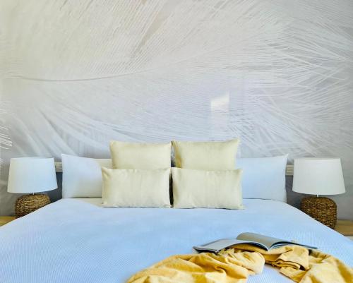 a bedroom with a bed with white walls and two lamps at Canaryislandshost l Room in Playa Blanca