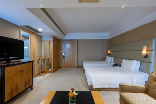 a hotel room with two beds and a flat screen tv at DoubleTree by Hilton Shanghai Pudong - Present welcome cookie in Shanghai