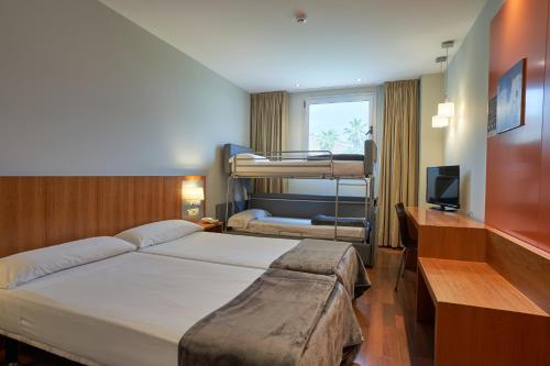 a hotel room with two bunk beds and a television at Hotel AG Express Elche in Torrellano