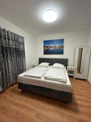 a bedroom with a large bed in a room at Hotel Restaurant Rhodos in Elsterwerda