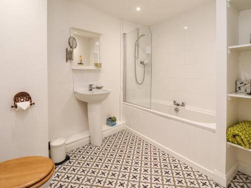 a bathroom with a sink and a shower and a toilet at 18 The Old Corn Exchange in Berwick-Upon-Tweed