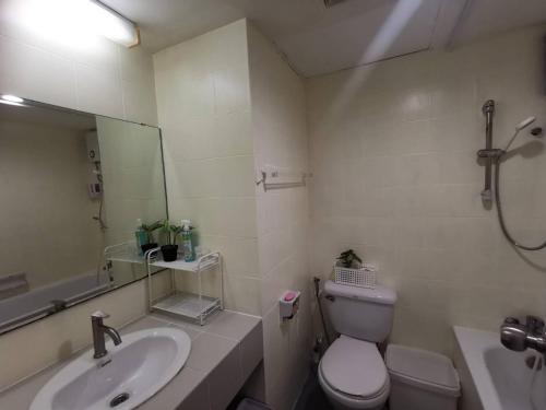 a bathroom with a sink and a toilet and a mirror at Tower Resident in the Heart of Bangkok Shopping Center in Makkasan