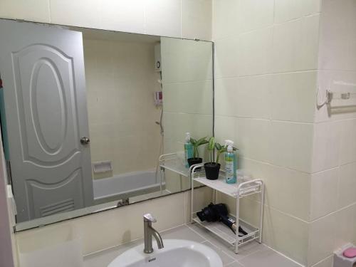 a bathroom with a sink and a large mirror at Tower Resident in the Heart of Bangkok Shopping Center in Makkasan