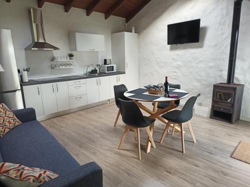 a kitchen and living room with a table and chairs at House to relax El Tanque in Tanque