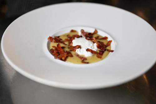 a bowl of food on a plate on a table at Rifugio Cereda in Fiera di Primiero
