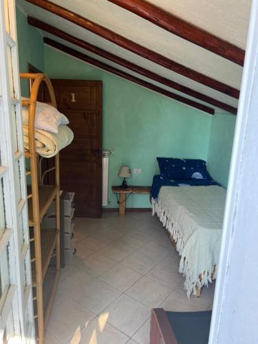 a bedroom with a bunk bed and a ladder at Camera Singola con Terrazza Panoramica in Serina