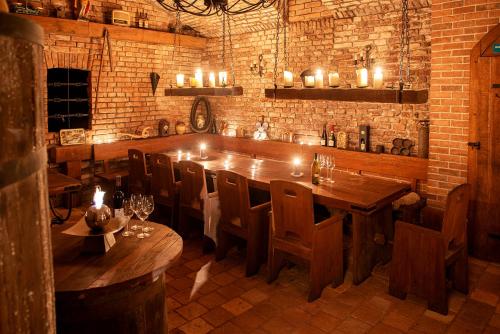a restaurant with a large wooden table and chairs at Residence Hattrick in Prague