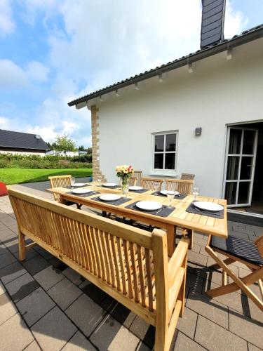 a wooden table and chairs on a patio at Winterberg Chalet 21096 in Winterberg