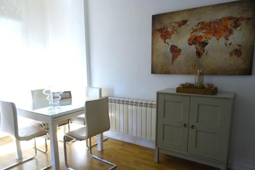 a dining room with a table and a map on the wall at Victoria Stay in Alcalá la Real